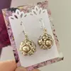 Dámske šité náušnice so striebrom Santia Handmade "Gulička" | Tmavozlatá